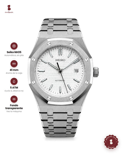 Reloj octagonal de acero con tornillos en el bisel, carátula blanca cuadriculada y fecha a las 3